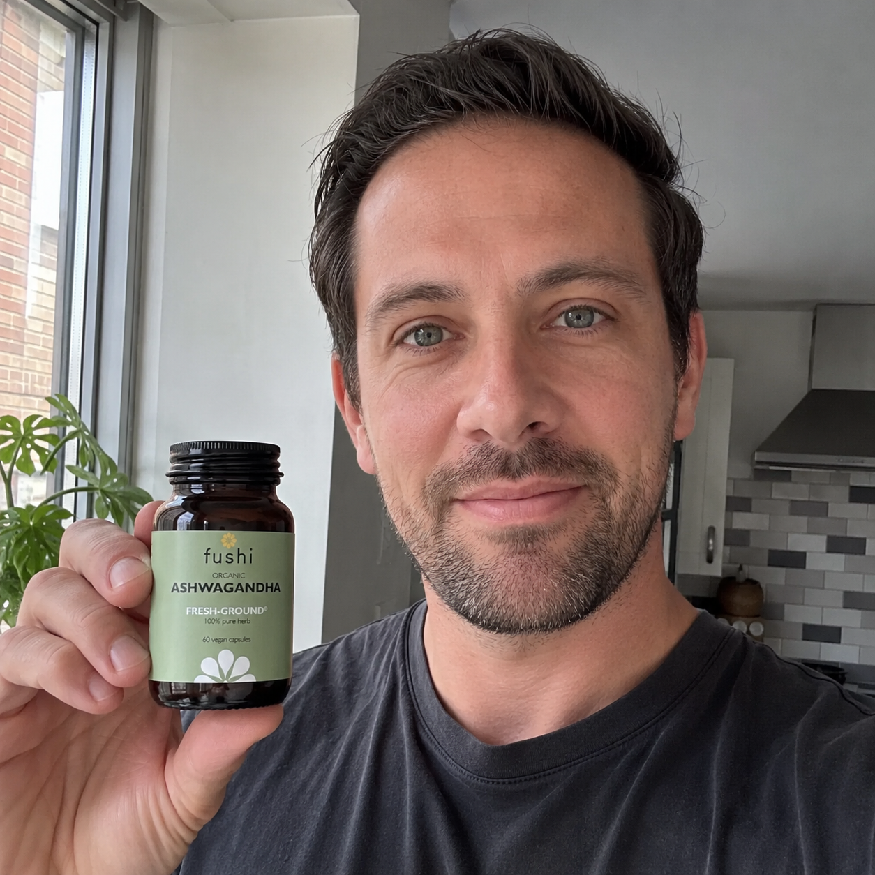 A real customer holding the Fushi Ashwagandha jar